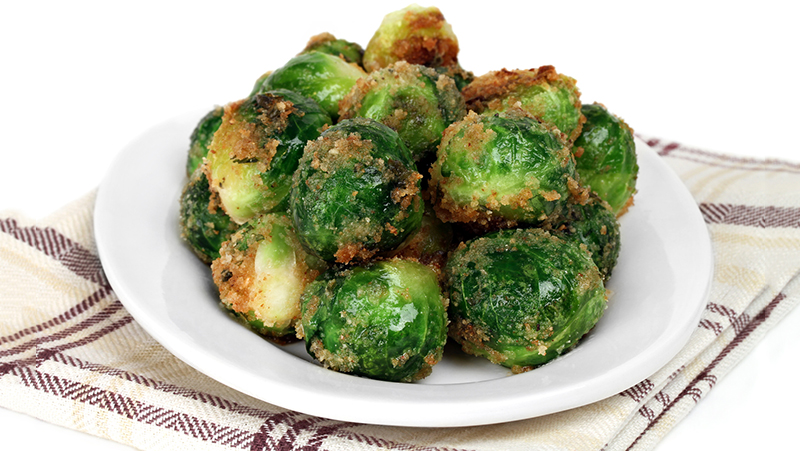 Fresh roasted brussel sprouts. Macro image with a white background for copy space.