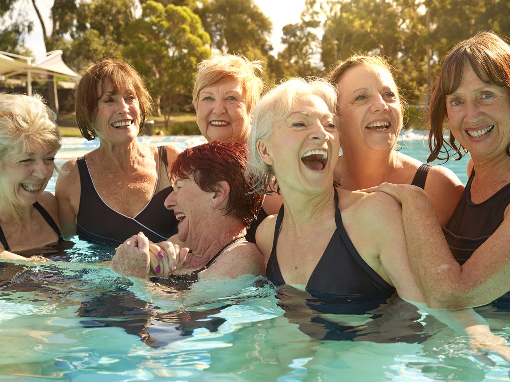 group of older women in pool having fun