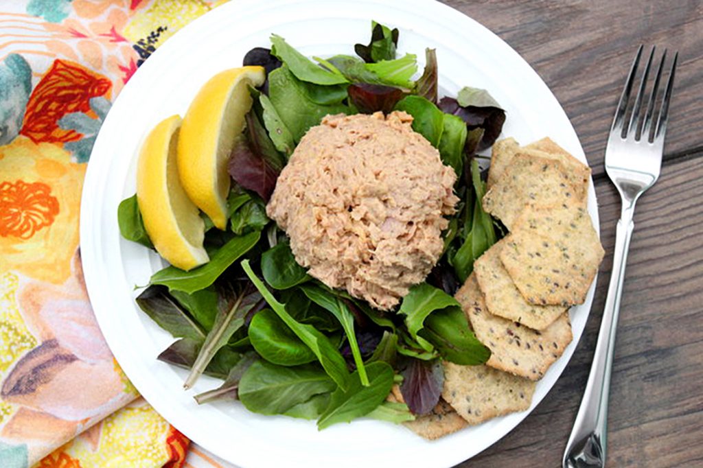 tuna salad on bed of lettuce with whole grain crackers