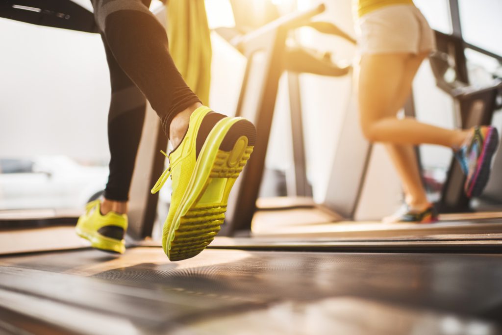 people with yellow shoes on treadmill