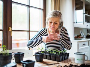 older woman with indoor plants