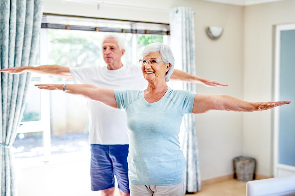 older couple exercising at home