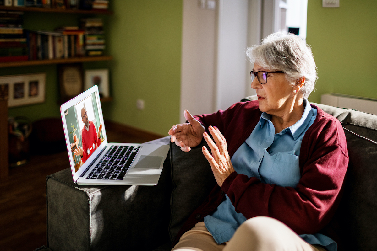 senior woman on a video chat with therapist