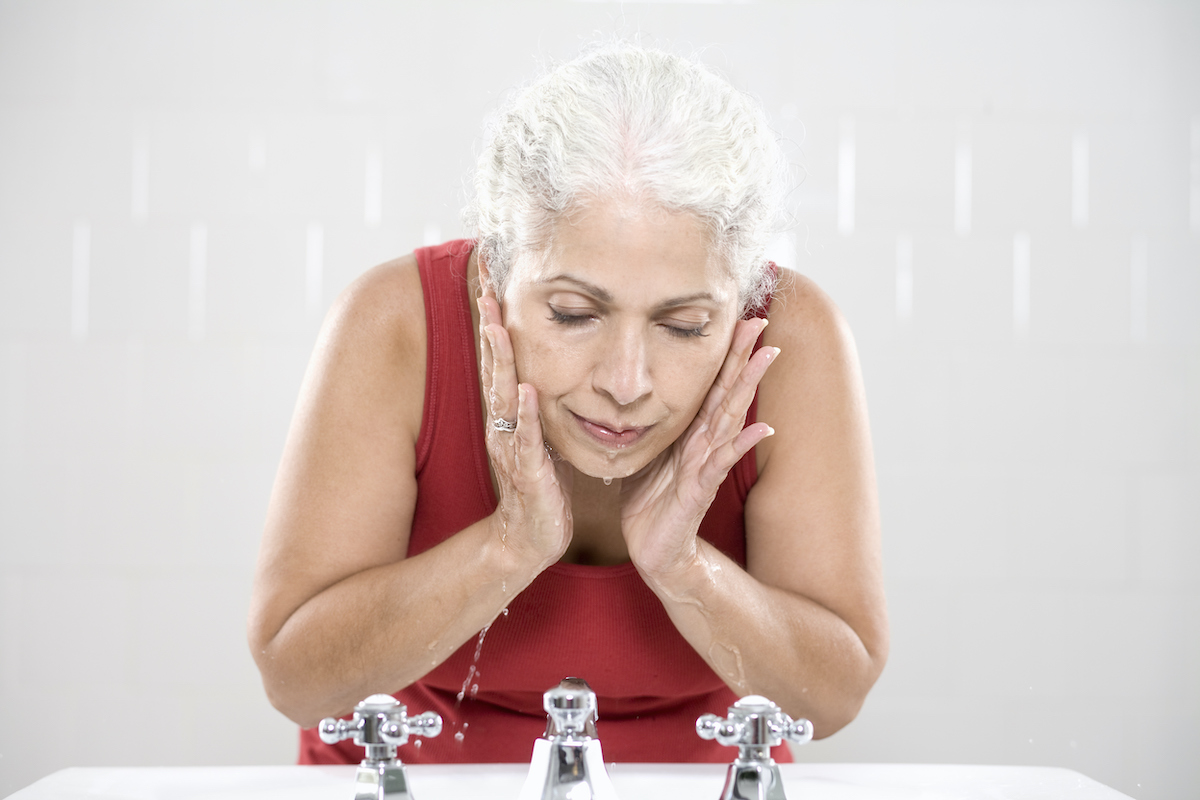 Mature woman washing her face