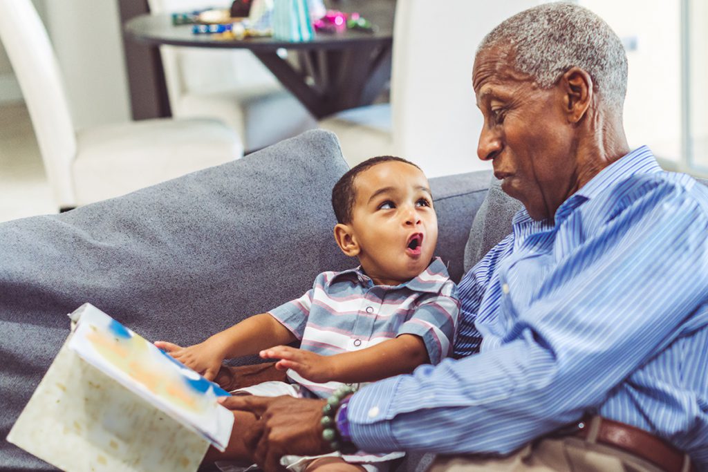Grandpa and grandchild reading a book