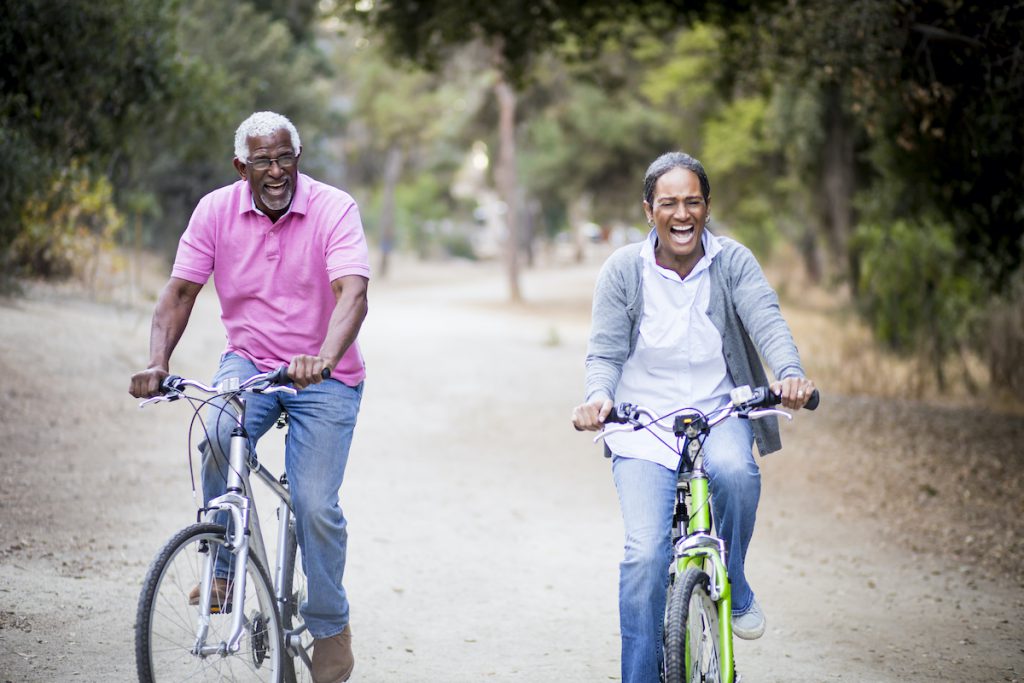 Senior Black couple riding bikes together
