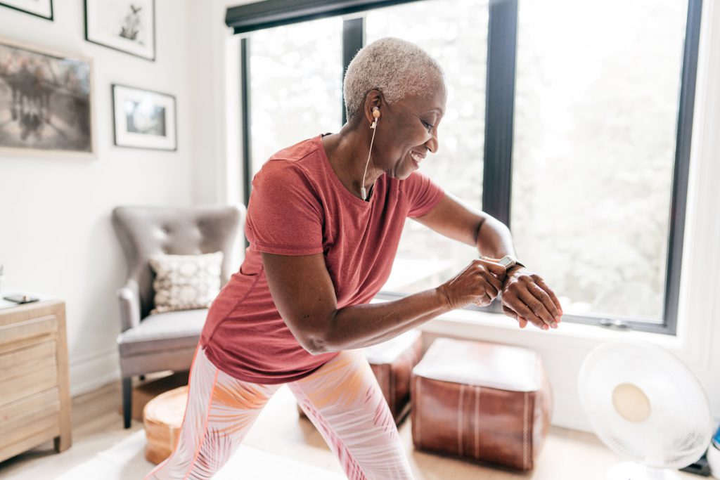 Senior Black woman exercising at home for a story on cardio workouts for seniors